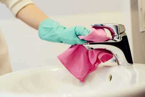 Cleaner following safe work procedures in a professional indoor setting